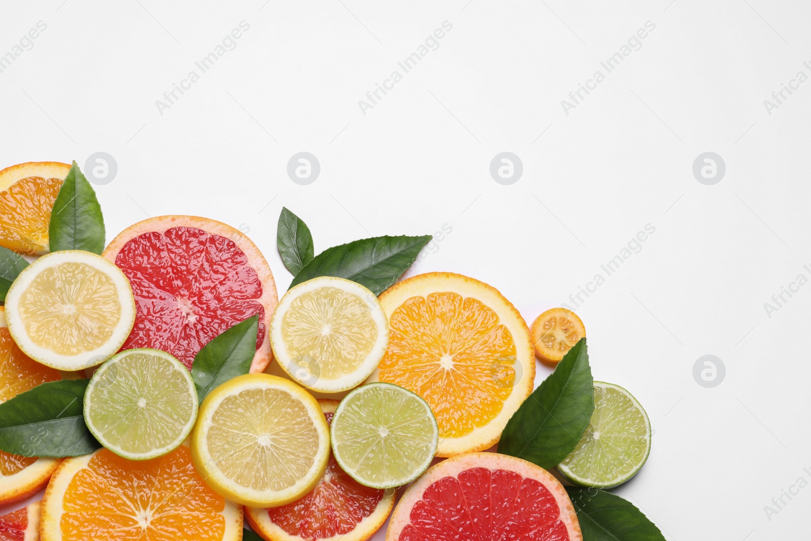 Photo of Fresh juicy citrus fruits with green leaves on white background, flat lay. Space for text