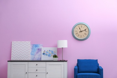 Photo of Room interior with stylish clock on wall. Time of day