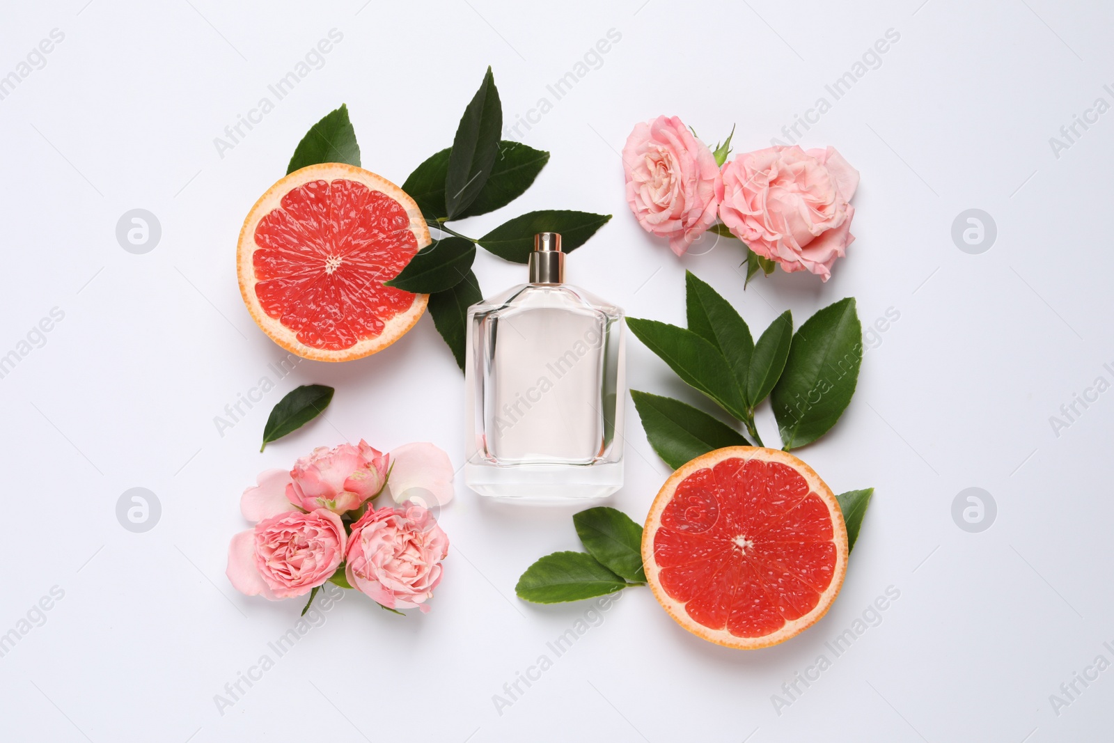 Photo of Composition with bottle of perfume and fresh citrus fruit on white background, top view