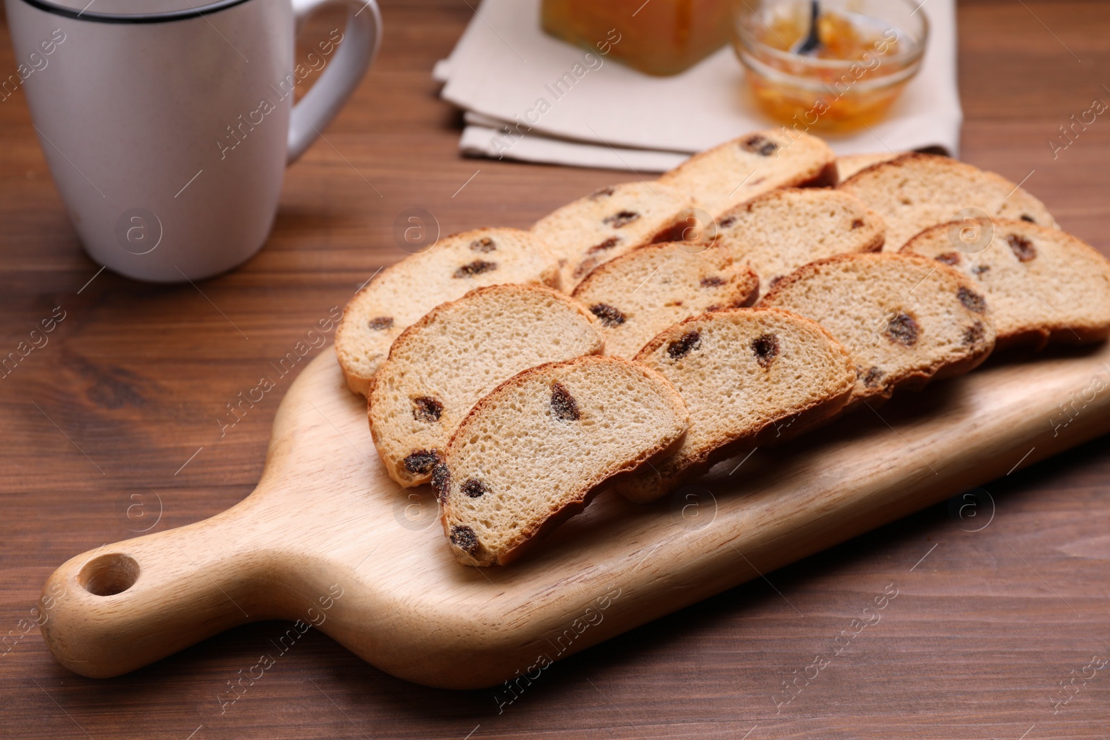 Photo of Sweet hard chuck crackers with raisins on wooden table