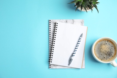 Photo of Flat lay composition with notebooks and coffee on color background