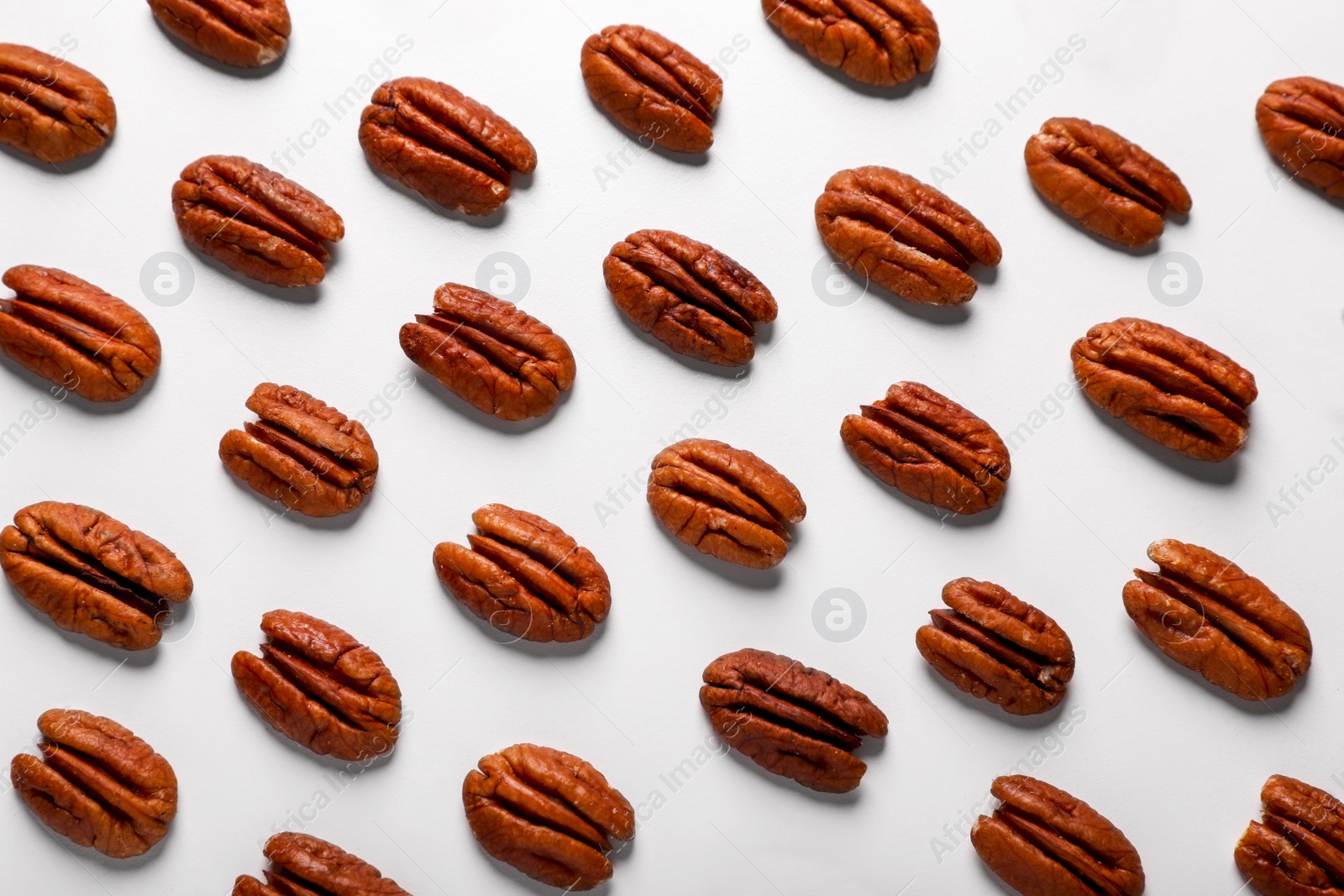 Photo of Delicious fresh pecan nuts on white background, flat lay