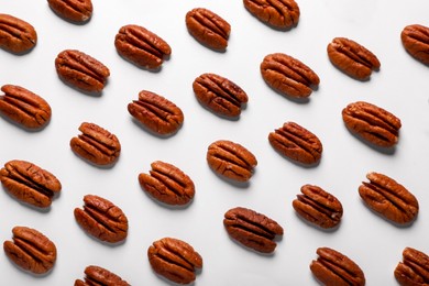 Delicious fresh pecan nuts on white background, flat lay