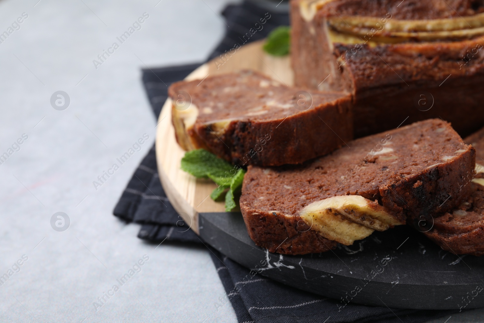 Photo of Delicious banana bread on grey table, closeup. Space for text