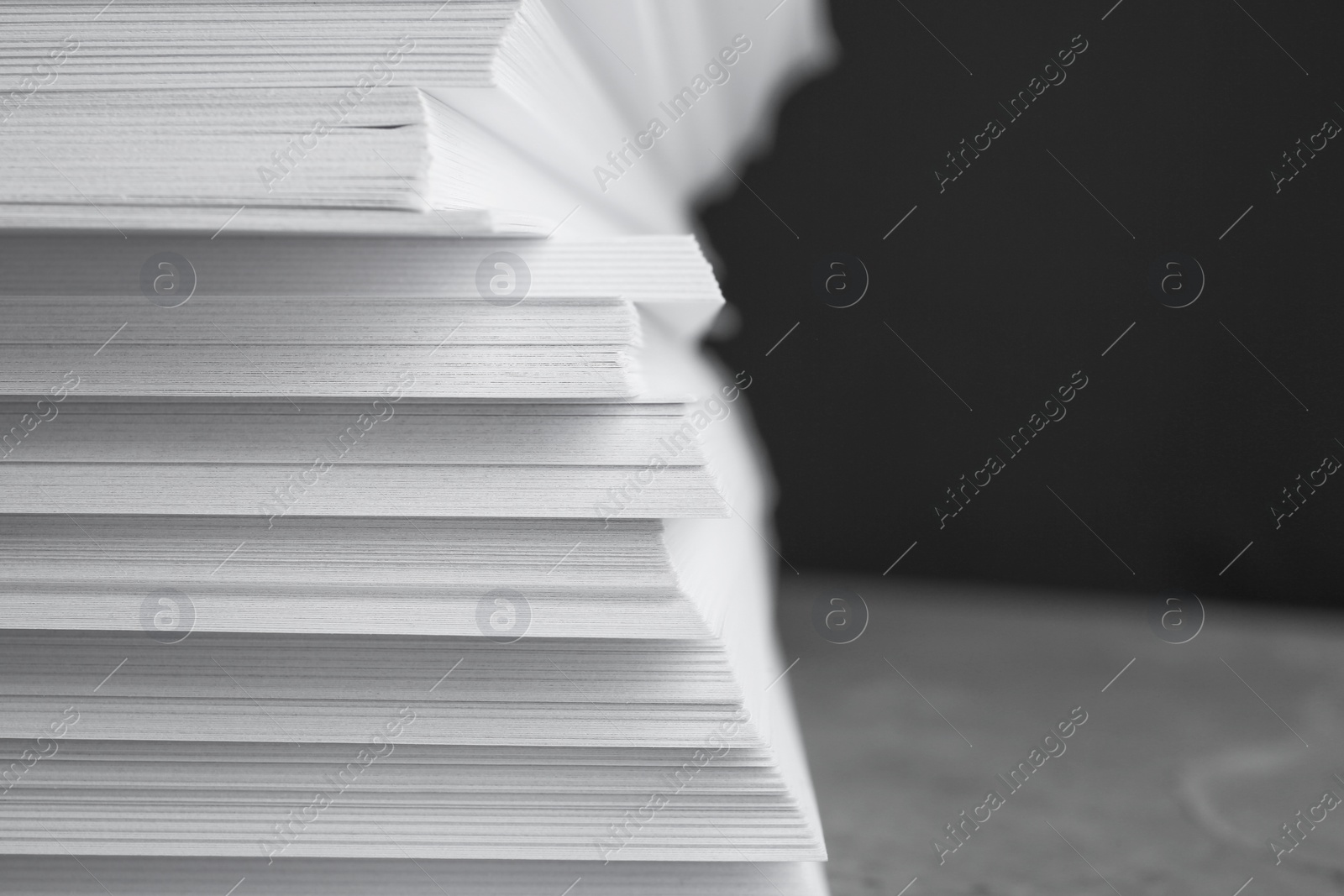 Photo of Stack of blank white paper on table, closeup. Space for text