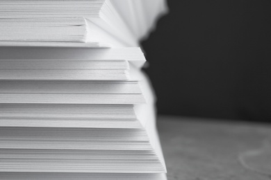 Photo of Stack of blank white paper on table, closeup. Space for text