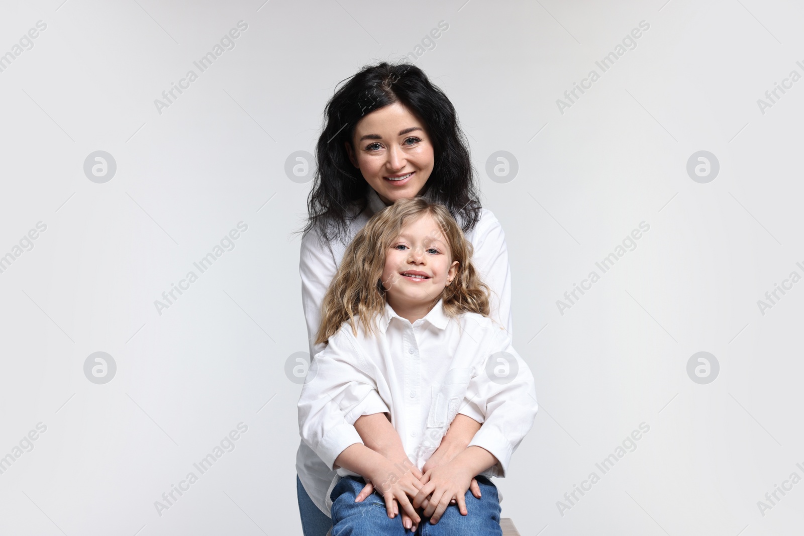 Photo of Beautiful mother with little daughter on white background