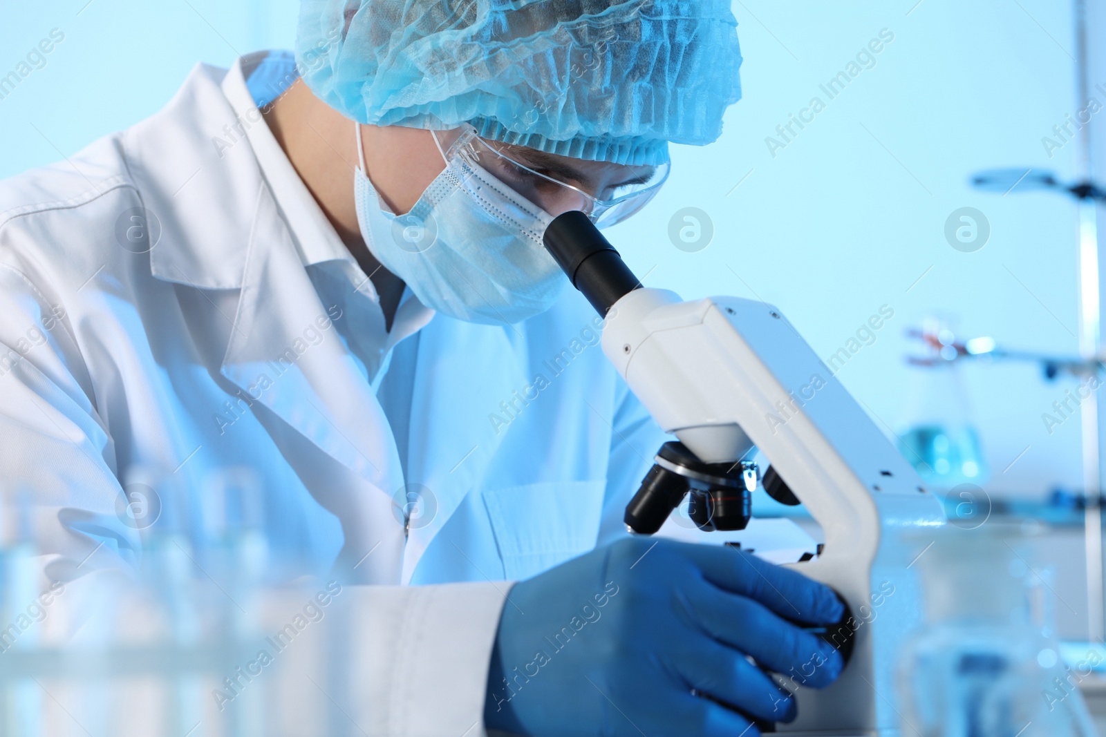 Photo of Scientist working with microscope in laboratory. Medical research