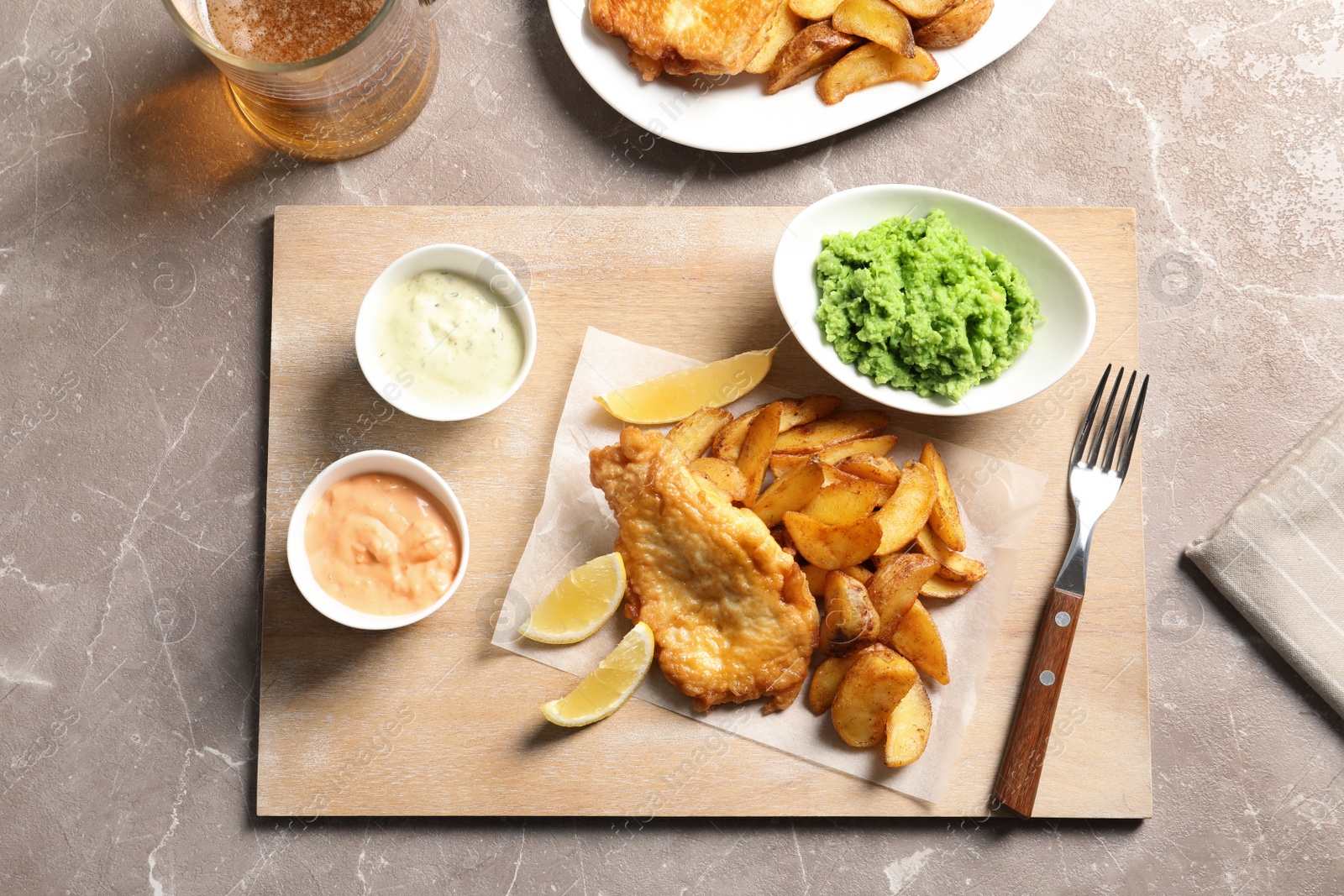 Photo of British traditional fish, potato chips and mushy peas on color background, top view