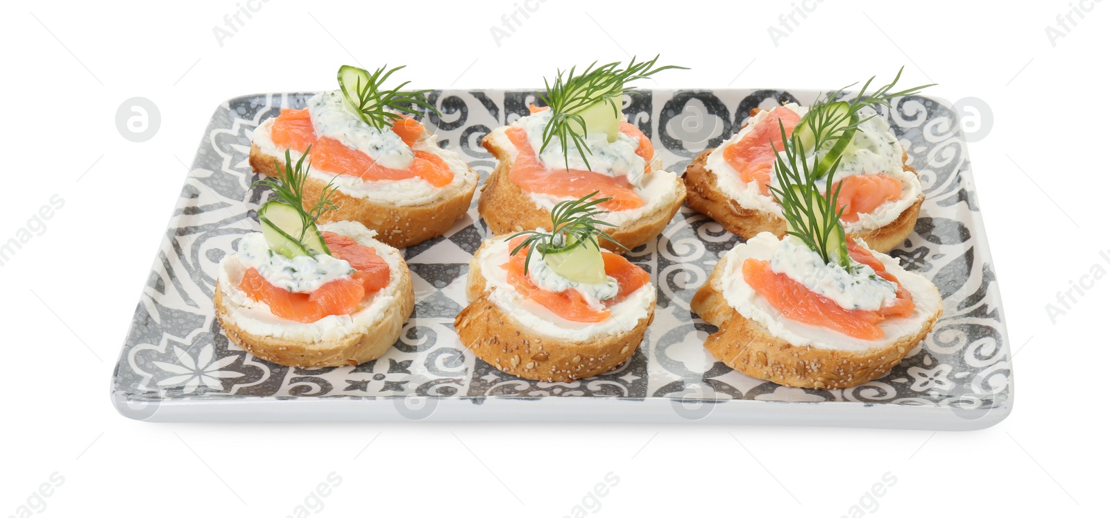 Photo of Tasty canapes with salmon, cucumber, cream cheese and dill isolated on white