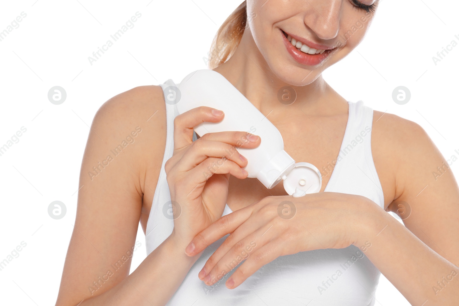 Photo of Young woman applying hand cream on white background, closeup. Beauty and body care