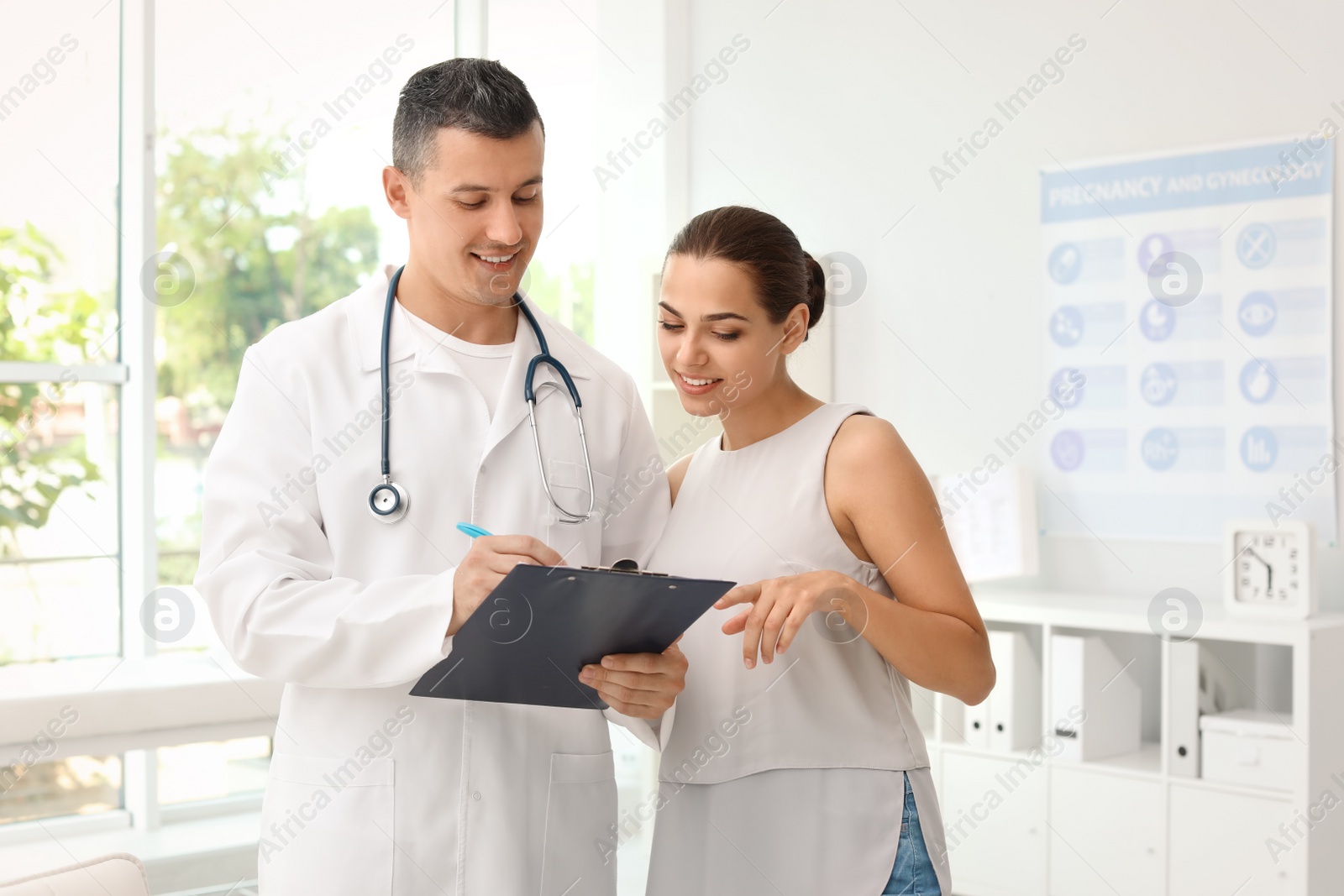 Photo of Young doctor speaking to patient in hospital