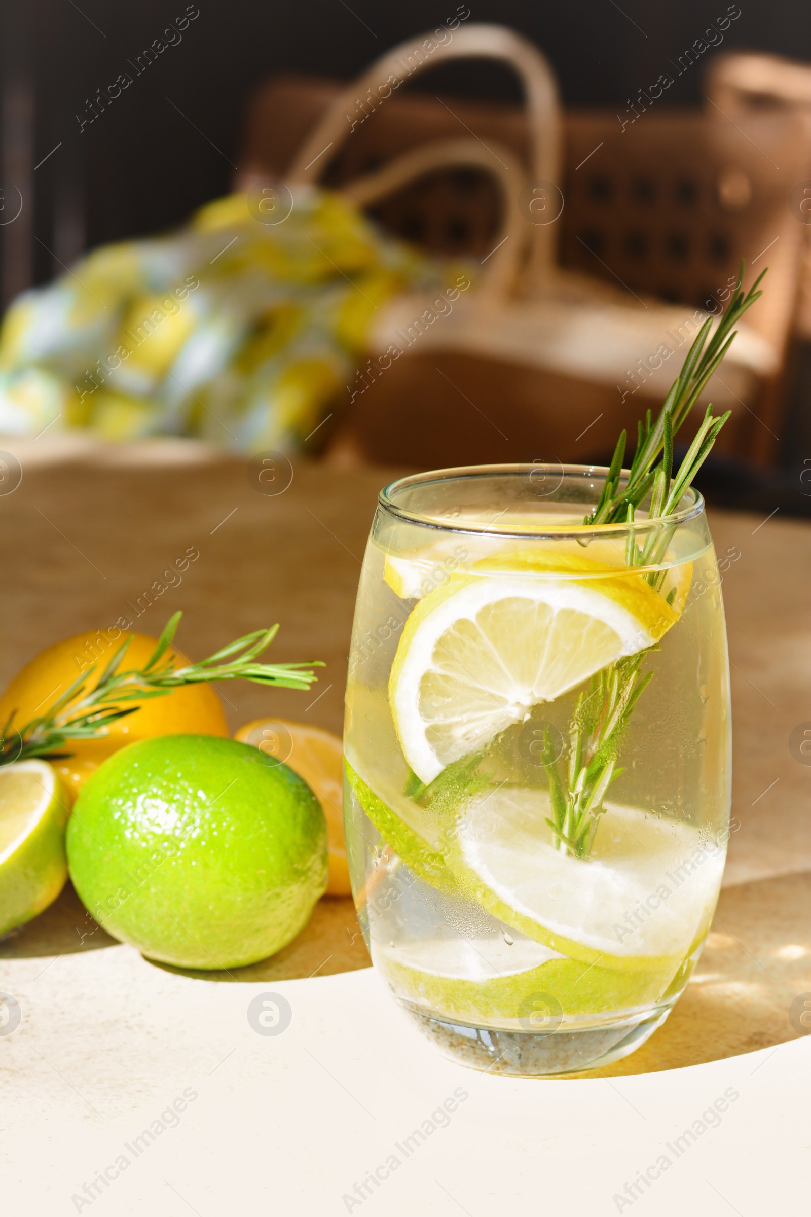 Photo of Tasty refreshing lemonade and ingredients on light table. Summer drink