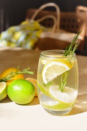 Tasty refreshing lemonade and ingredients on light table. Summer drink