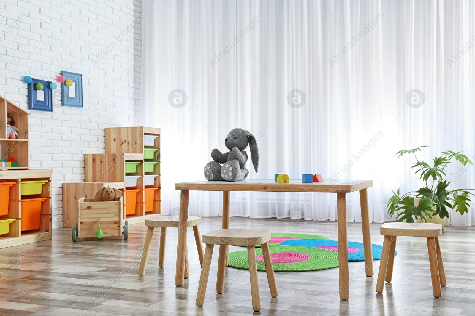 Photo of Modern child room interior with table and stools