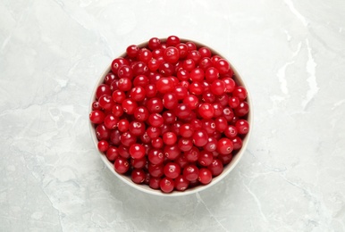 Photo of Tasty ripe cranberries on light grey marble table, top view