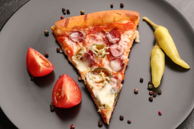 Photo of Plate with delicious pizza Diablo, pepper, tomato and peppercorns on table, closeup