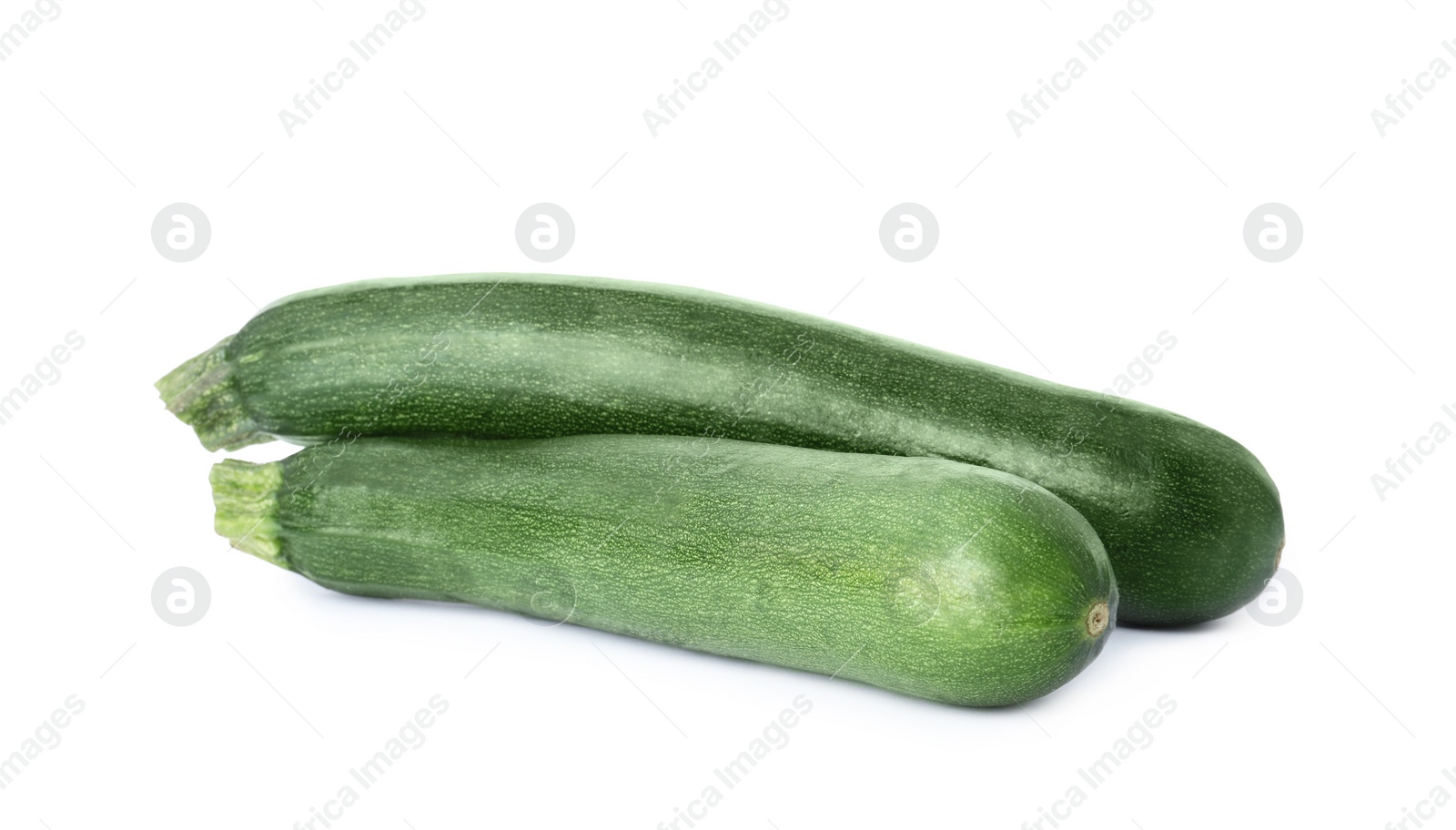 Photo of Raw green ripe zucchinis isolated on white