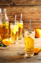 Photo of Delicious refreshing drink with orange slices on wooden table