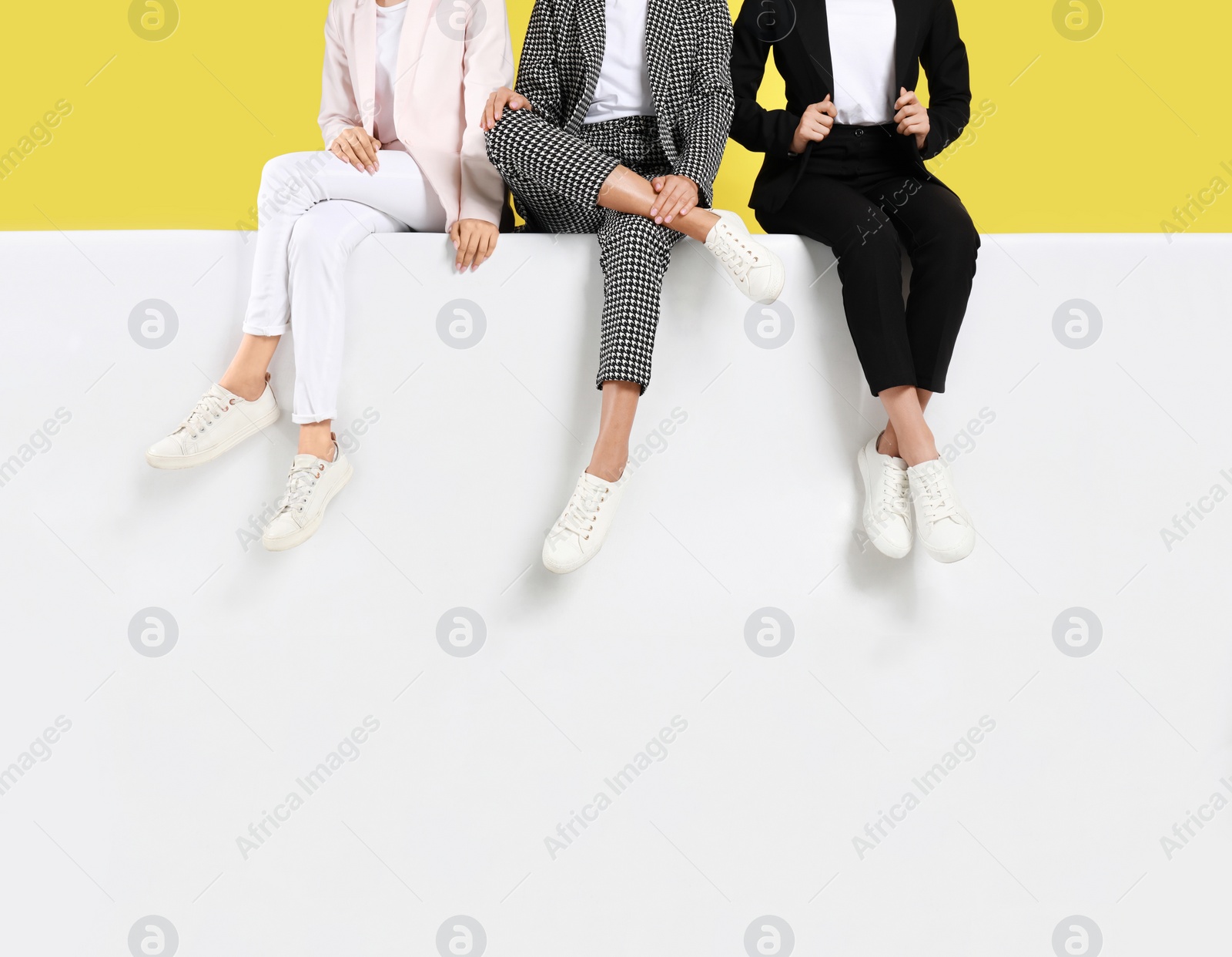 Photo of Women wearing stylish shoes on color background, closeup