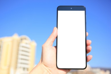 Man using weather forecast app on smartphone outdoors on sunny day, closeup