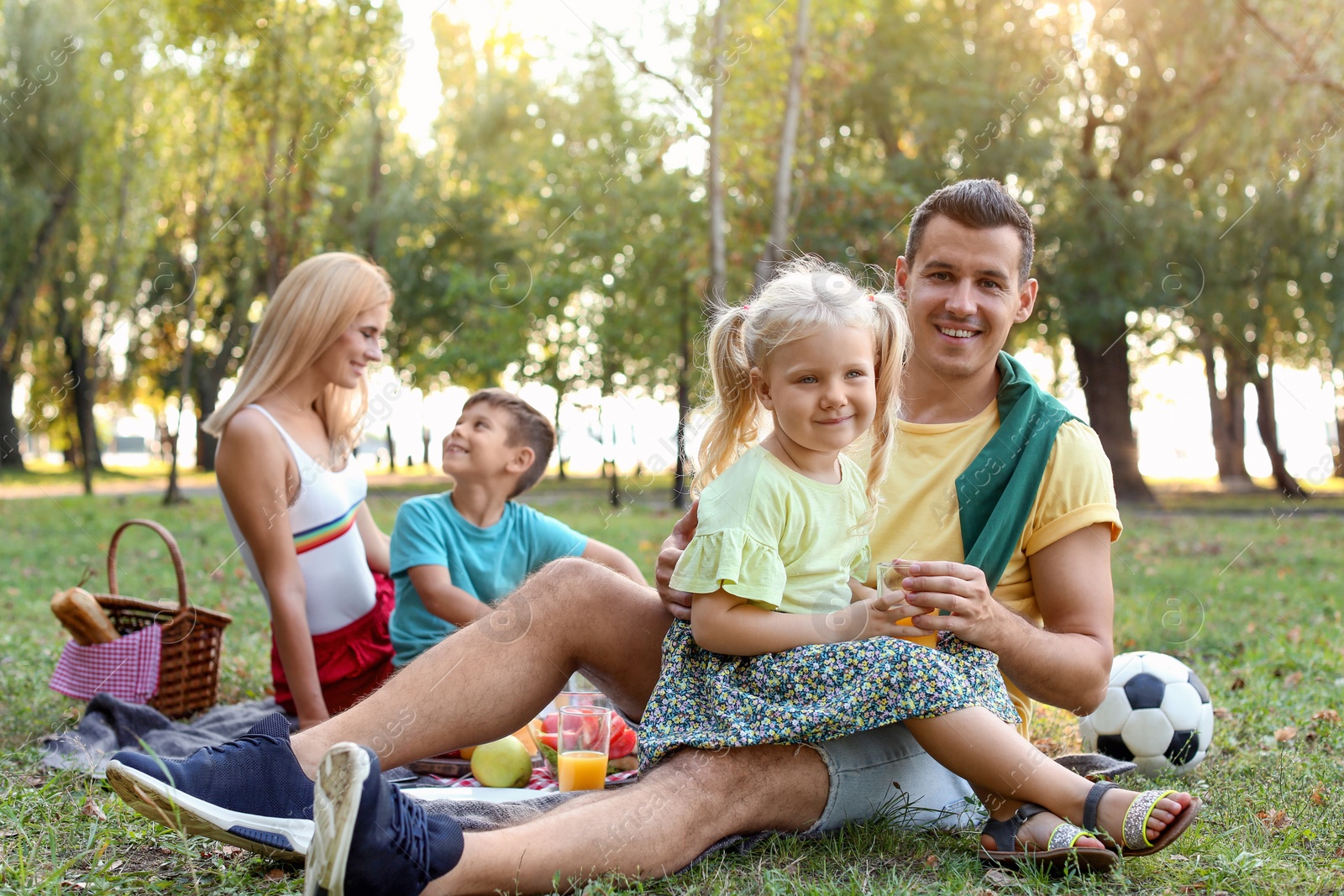 Photo of Happy family having picnic in park on sunny day