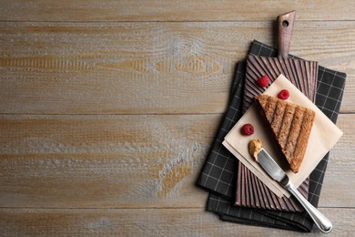 Image of Tasty sandwich with raspberry jam and peanut butter for breakfast on wooden table, flat lay. Space for text