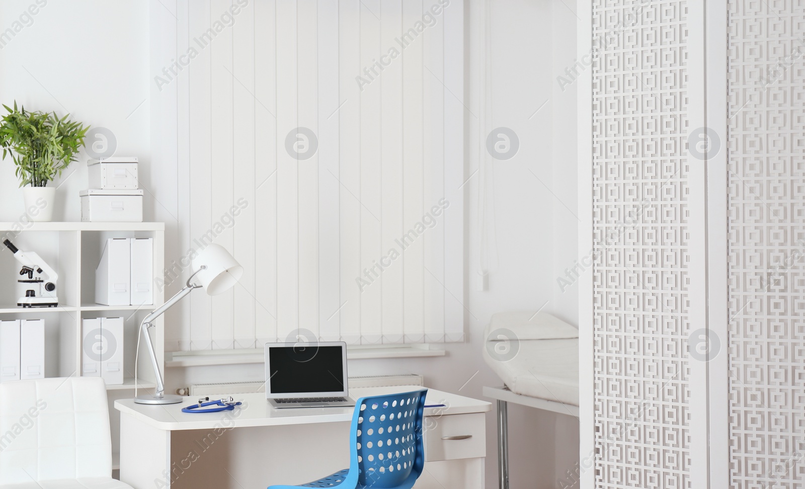 Photo of Doctor's workplace with modern laptop in medical office