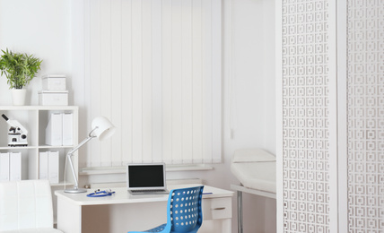 Doctor's workplace with modern laptop in medical office