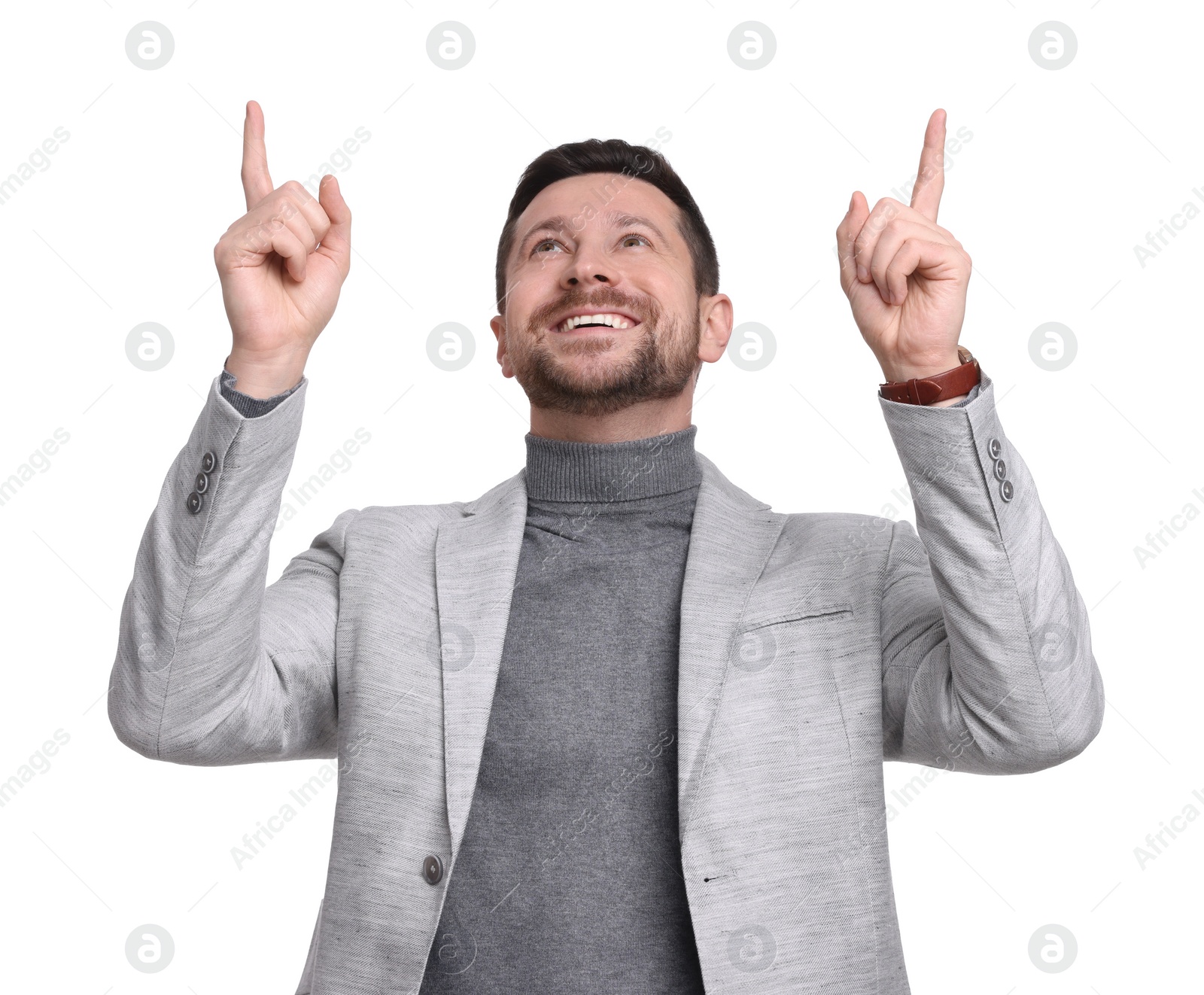 Photo of Handsome bearded businessman in suit pointing at something on white background