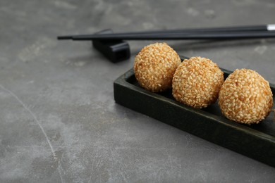 Delicious sesame balls on grey table. Space for text