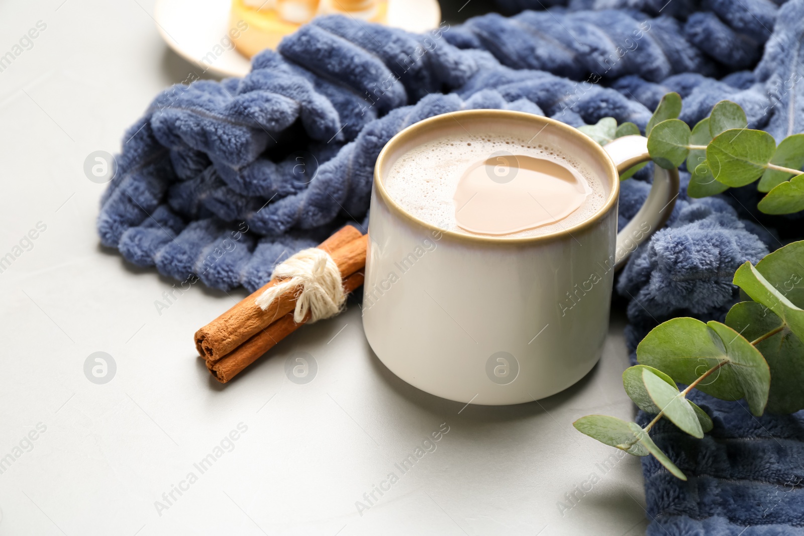 Photo of Composition with coffee and warm plaid on light table