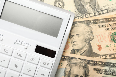 Photo of Calculator and money, closeup view. Tax accounting