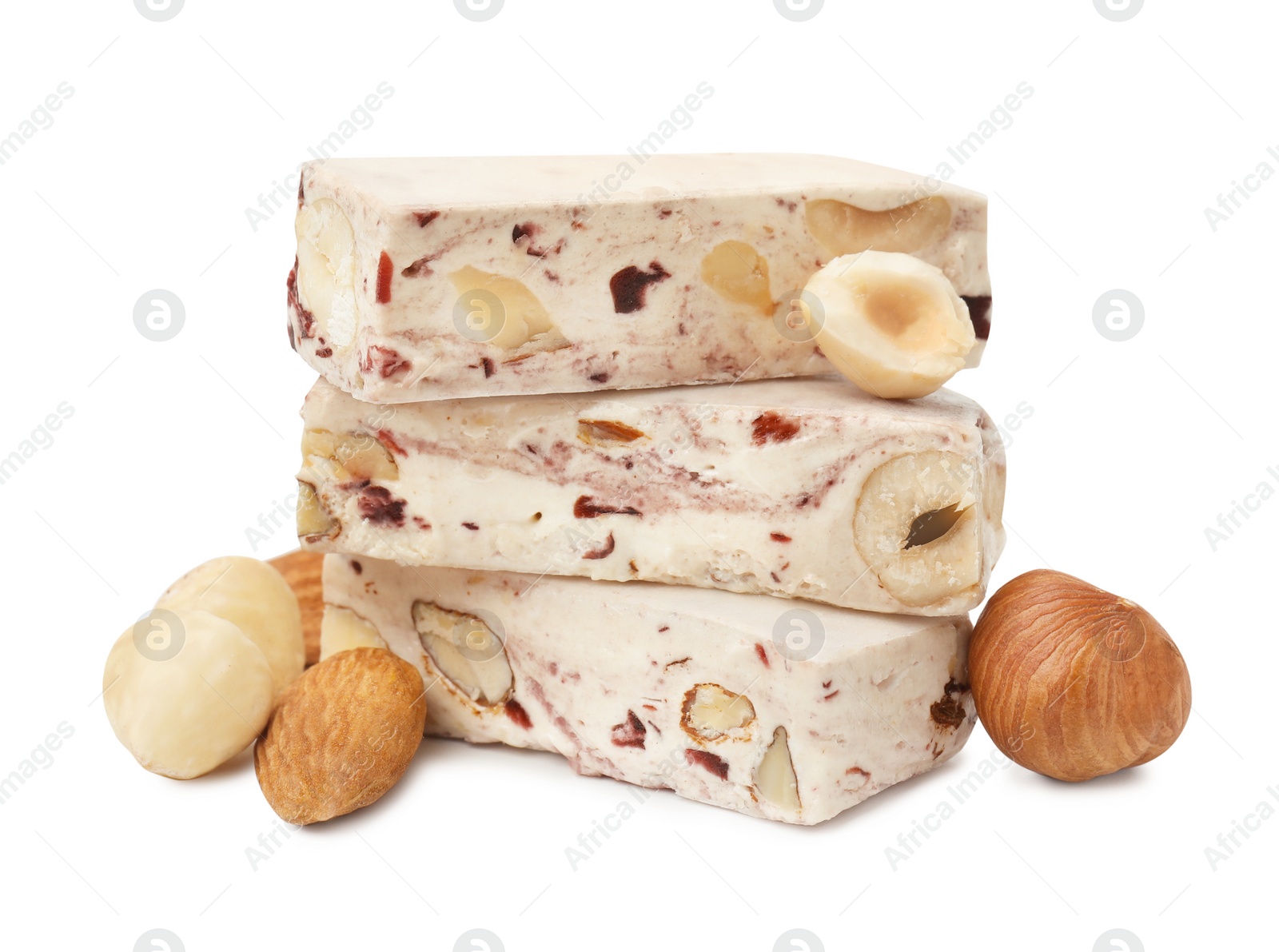 Photo of Pieces of delicious nougat and nuts on white background