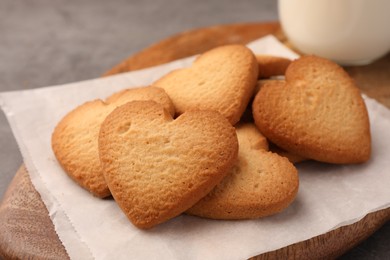 Photo of Heart shaped Danish butter cookies on wooden board, closeup