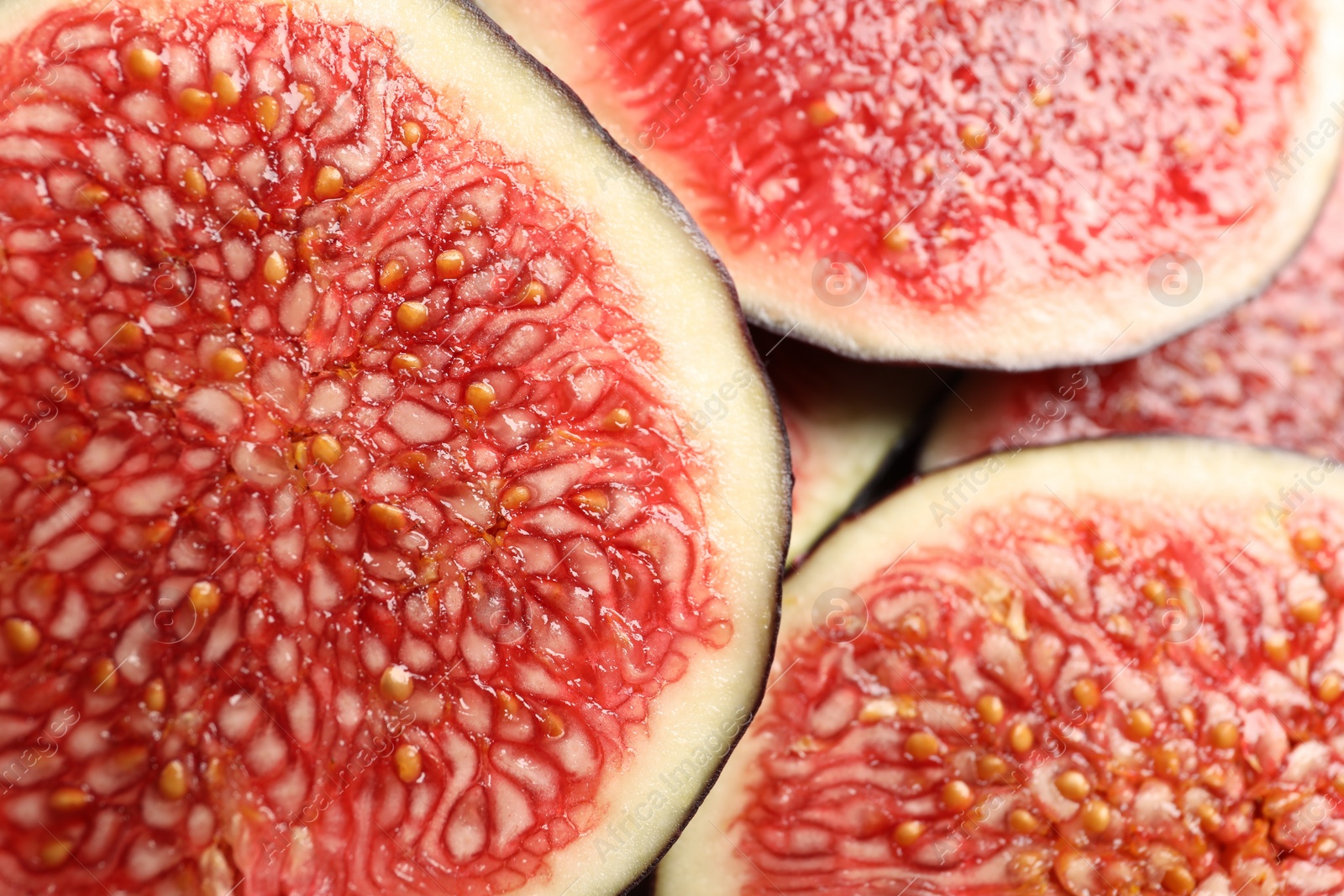 Photo of Pieces of fresh ripe figs as background, top view