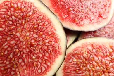 Photo of Pieces of fresh ripe figs as background, top view