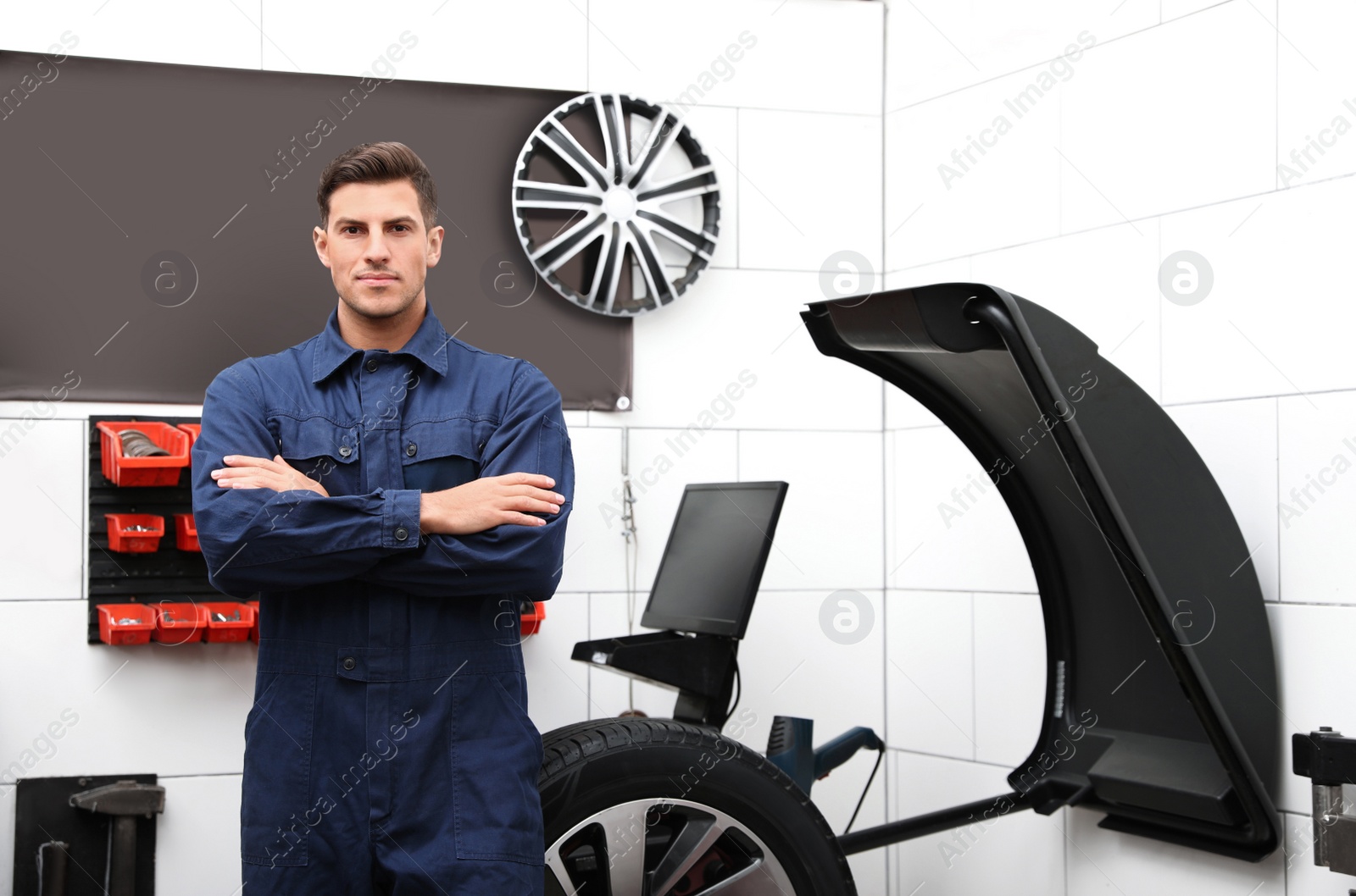 Photo of Man near wheel balancing machine at tire service