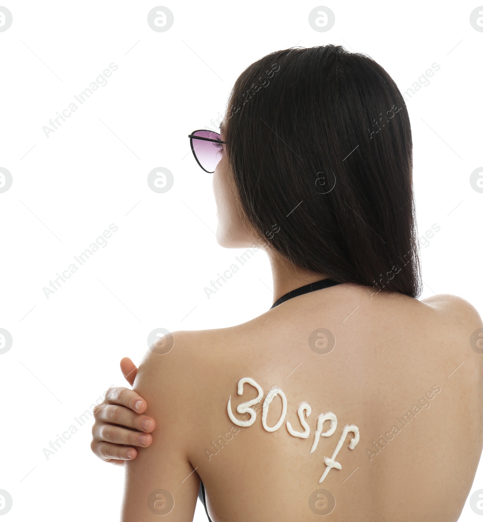 Photo of Text 30 SPF written with sun protection cream on woman's back against white background