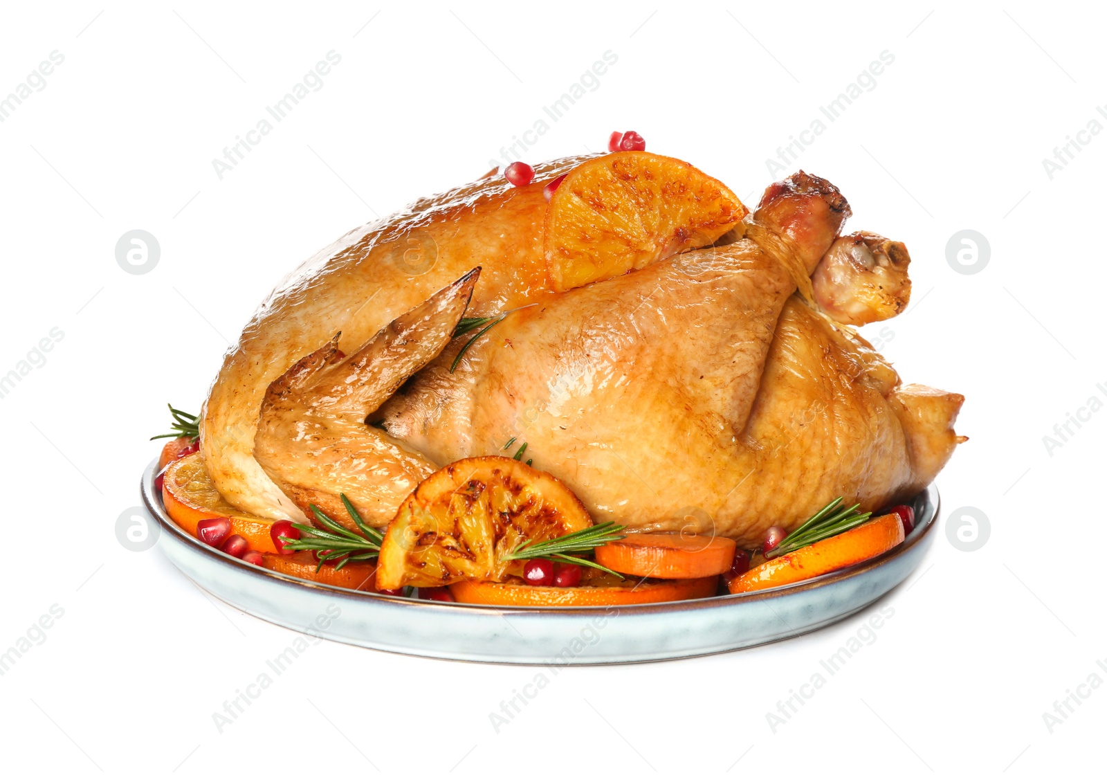 Photo of Roasted chicken with oranges, pomegranate and vegetables isolated on white