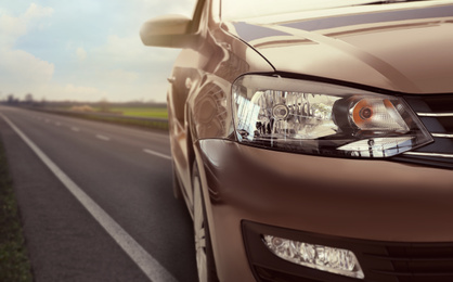 Road trip. Car driving on asphalt highway, closeup  