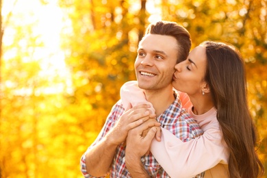 Photo of Happy couple in sunny park. Autumn walk