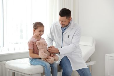 Children's doctor working with little patient in clinic