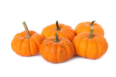 Pile of ripe orange pumpkins on white background