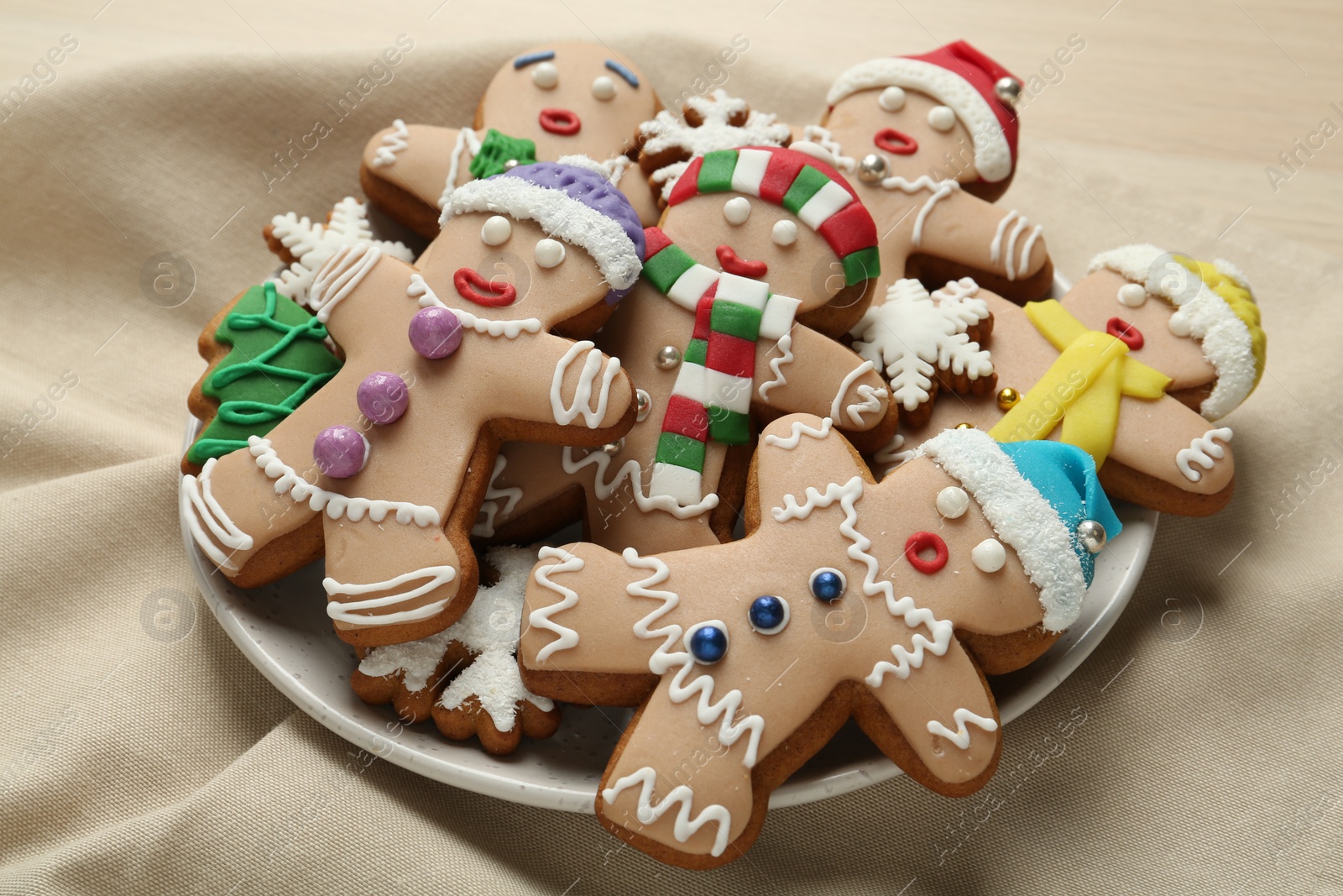 Photo of Delicious Christmas cookies on beige napkin, closeup view