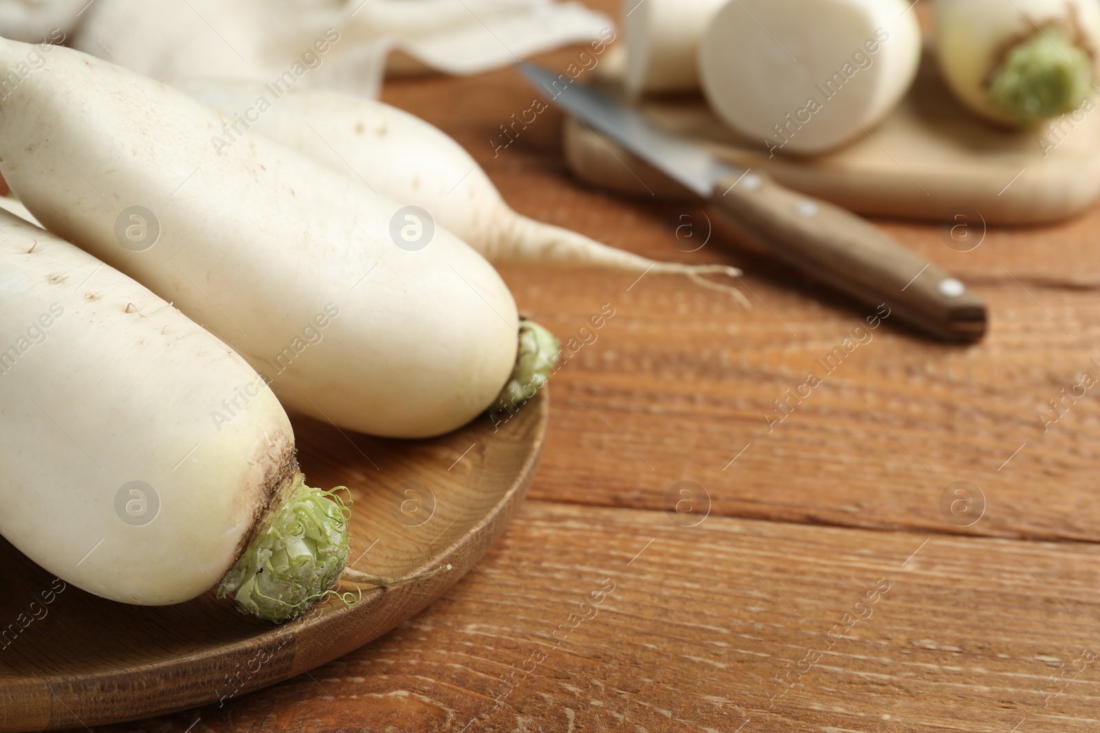 Photo of White turnips on wooden table, closeup. Space for text