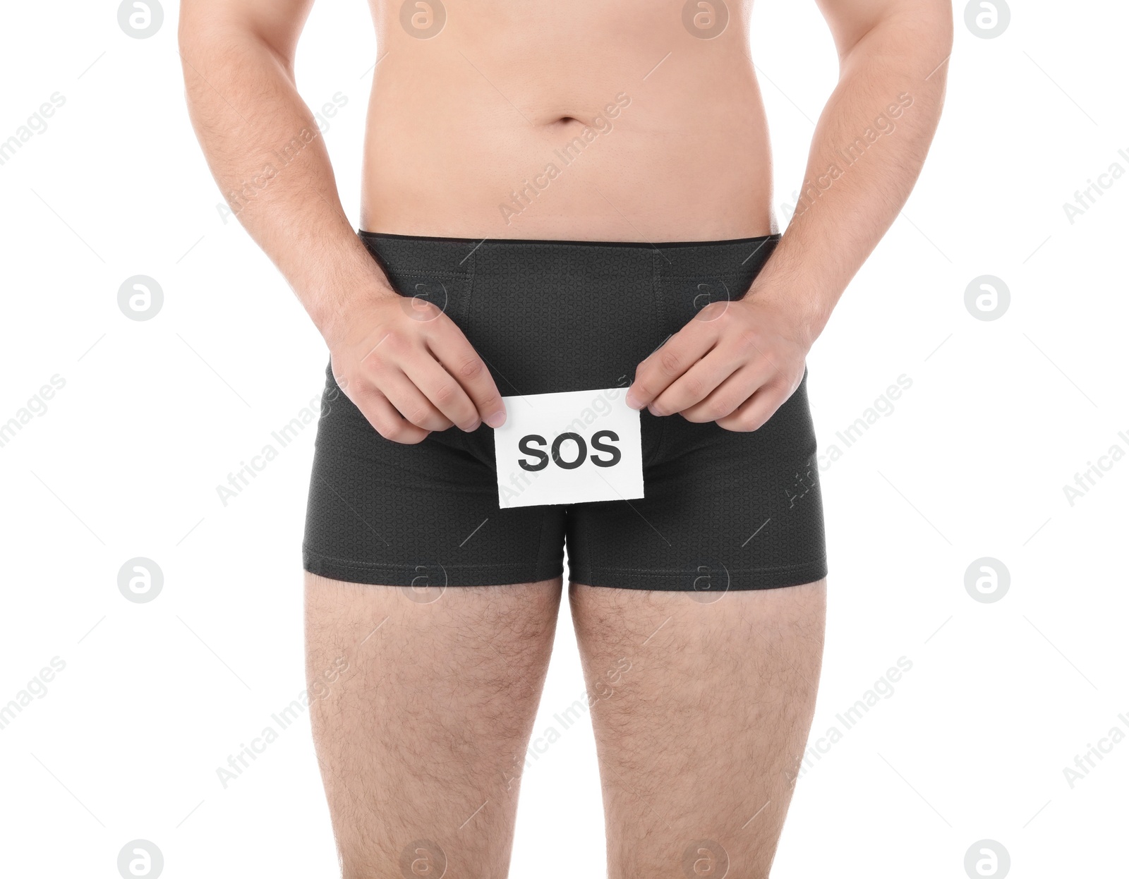 Photo of Young man with urological problems holding SOS sign on white background