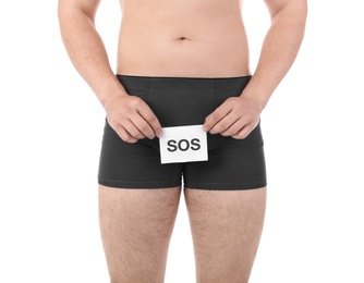 Photo of Young man with urological problems holding SOS sign on white background