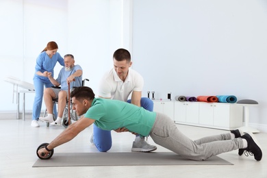 Professional physiotherapists working with patients in rehabilitation center