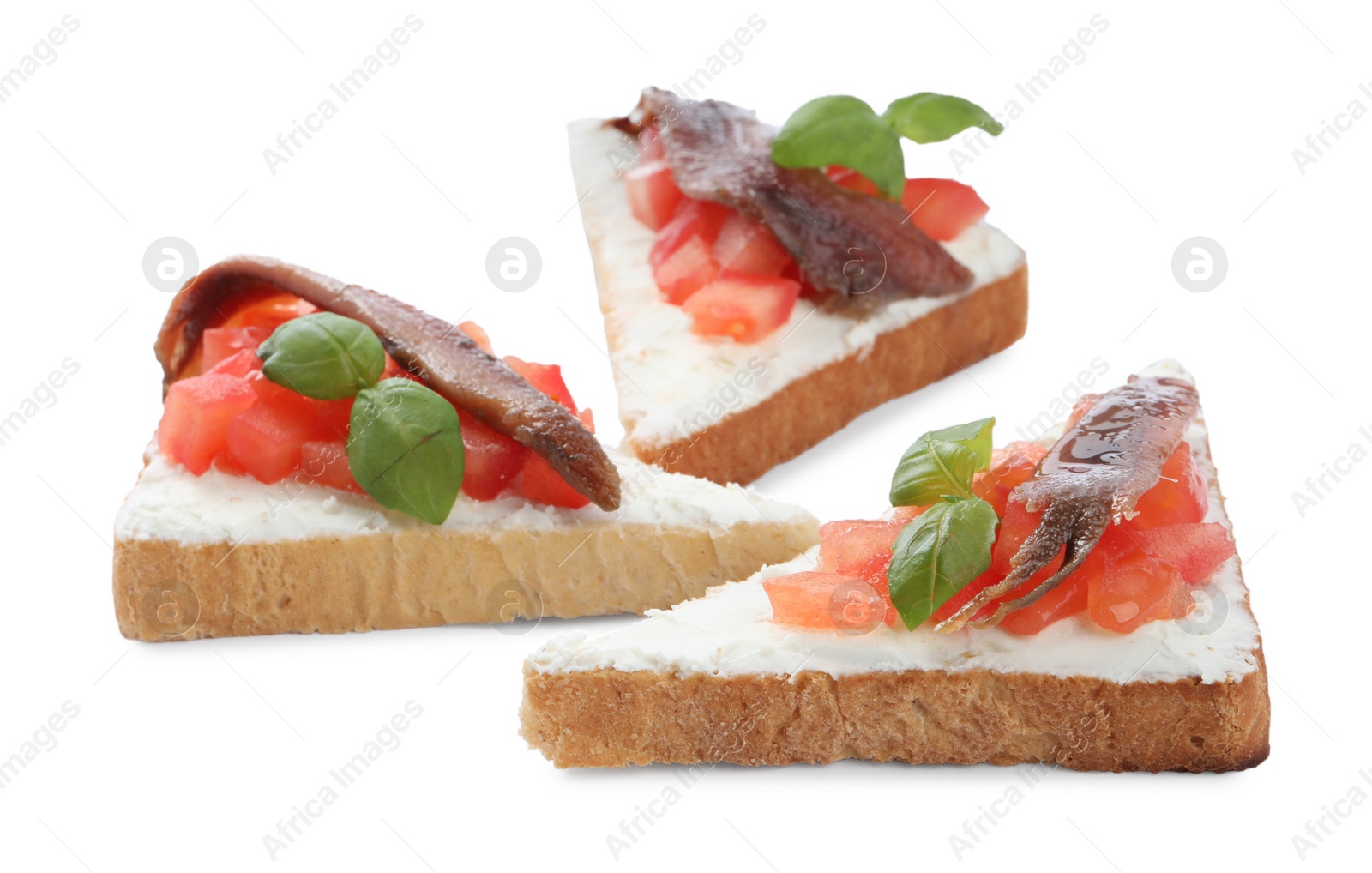 Photo of Delicious sandwiches with cream cheese, anchovies, tomatoes and basil on white background